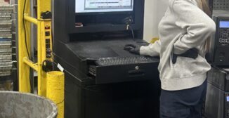 Operator checking manufacturing ERP schedule at work station