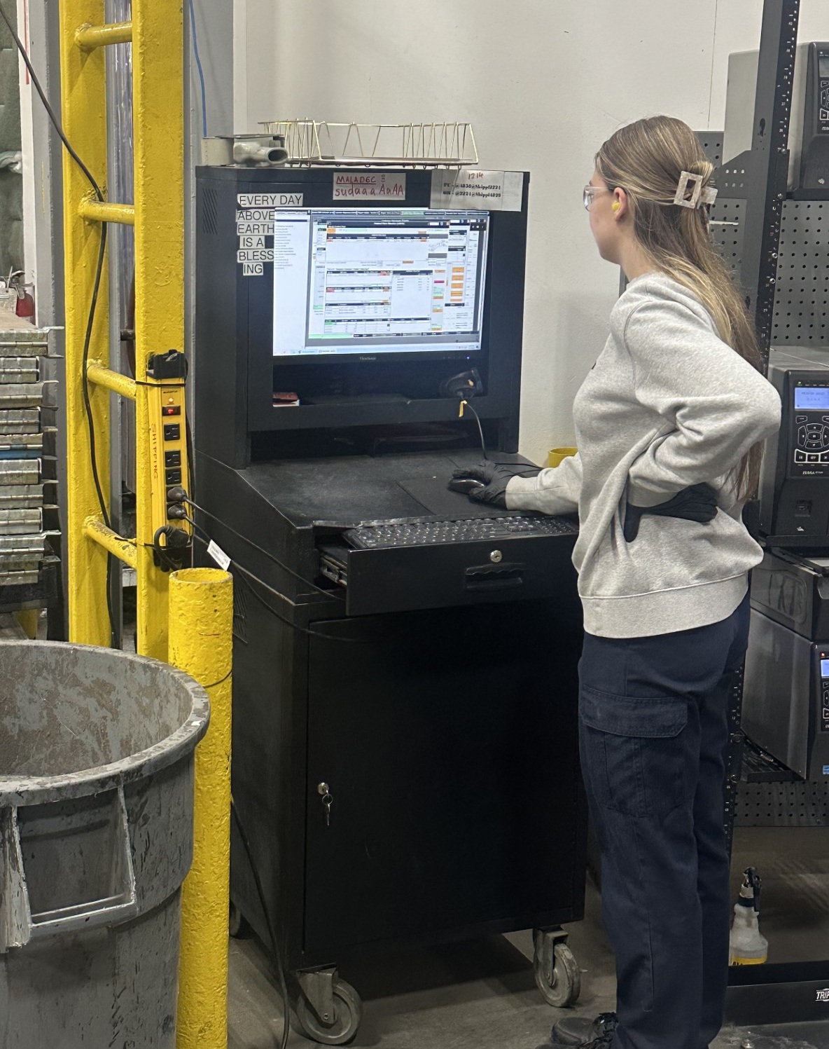 Operator checking manufacturing ERP schedule at work station