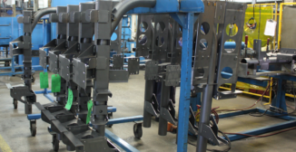 Tagged metal parts on a shop floor cart, part of OnRamp's customer supplied material tracking process