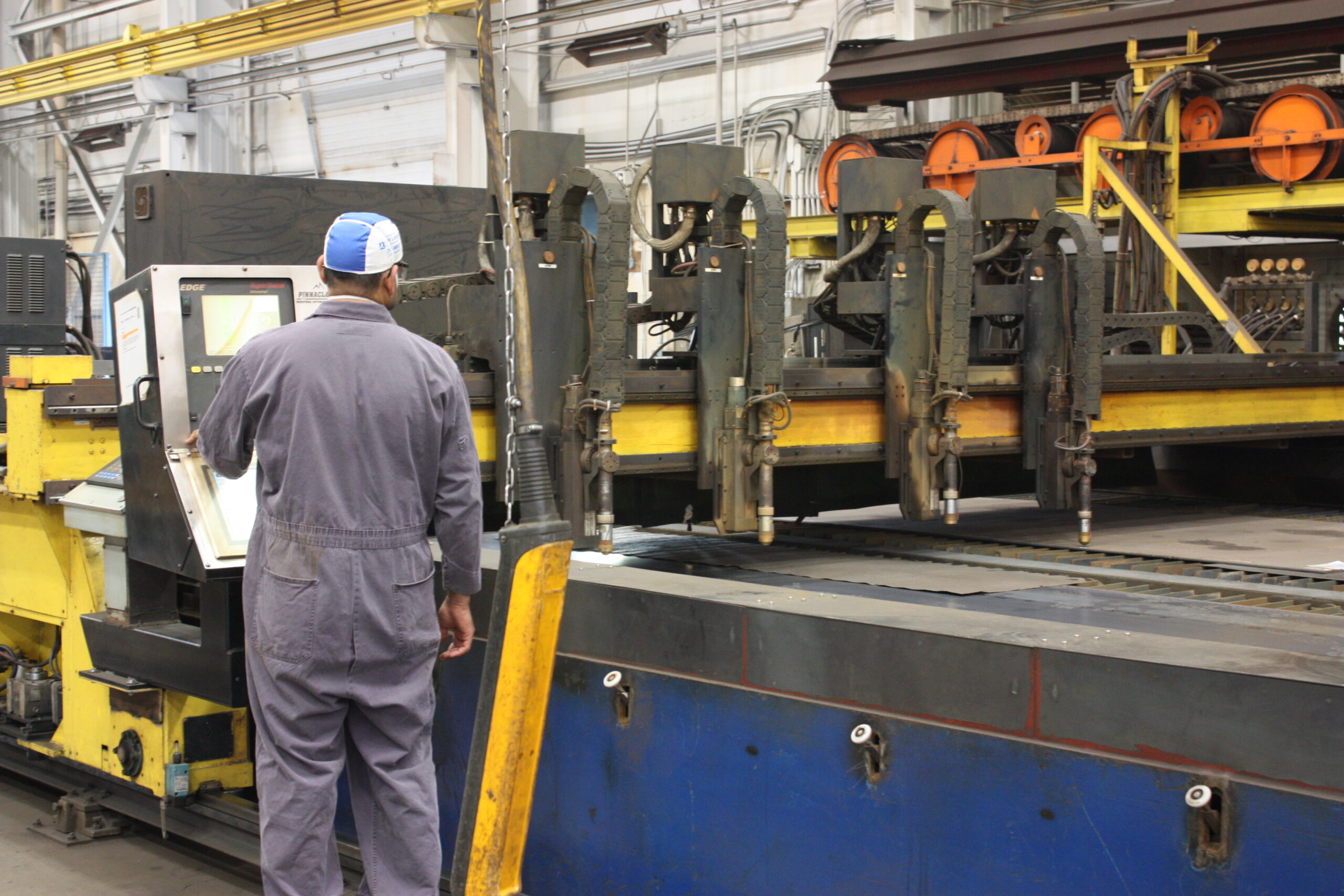 Manufacturing shop floor operator at CNC cutting machine
